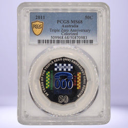 2011 50c Colored coin with 'Triple Zero Anniversary' design in a protective case, featuring PCGS grading label.