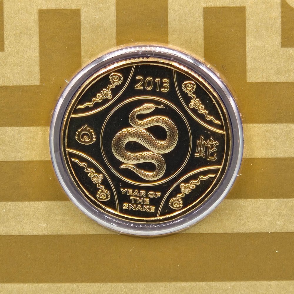 2013 $1 Lunar Series Year of the Snake Uncirculated Coin struck to specimen quality reverse with snake, year above, 'Year of the Snake' text below and Chinese motifs