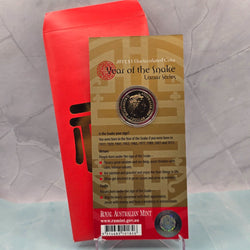 2013 $1 Lunar Series Year of the Snake Uncirculated Coin struck to specimen quality with red envelope - back of card