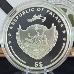 Silver coin from the Republic of Palau with a shield design and text 'Republic of Palau Rainbow's End 5$'