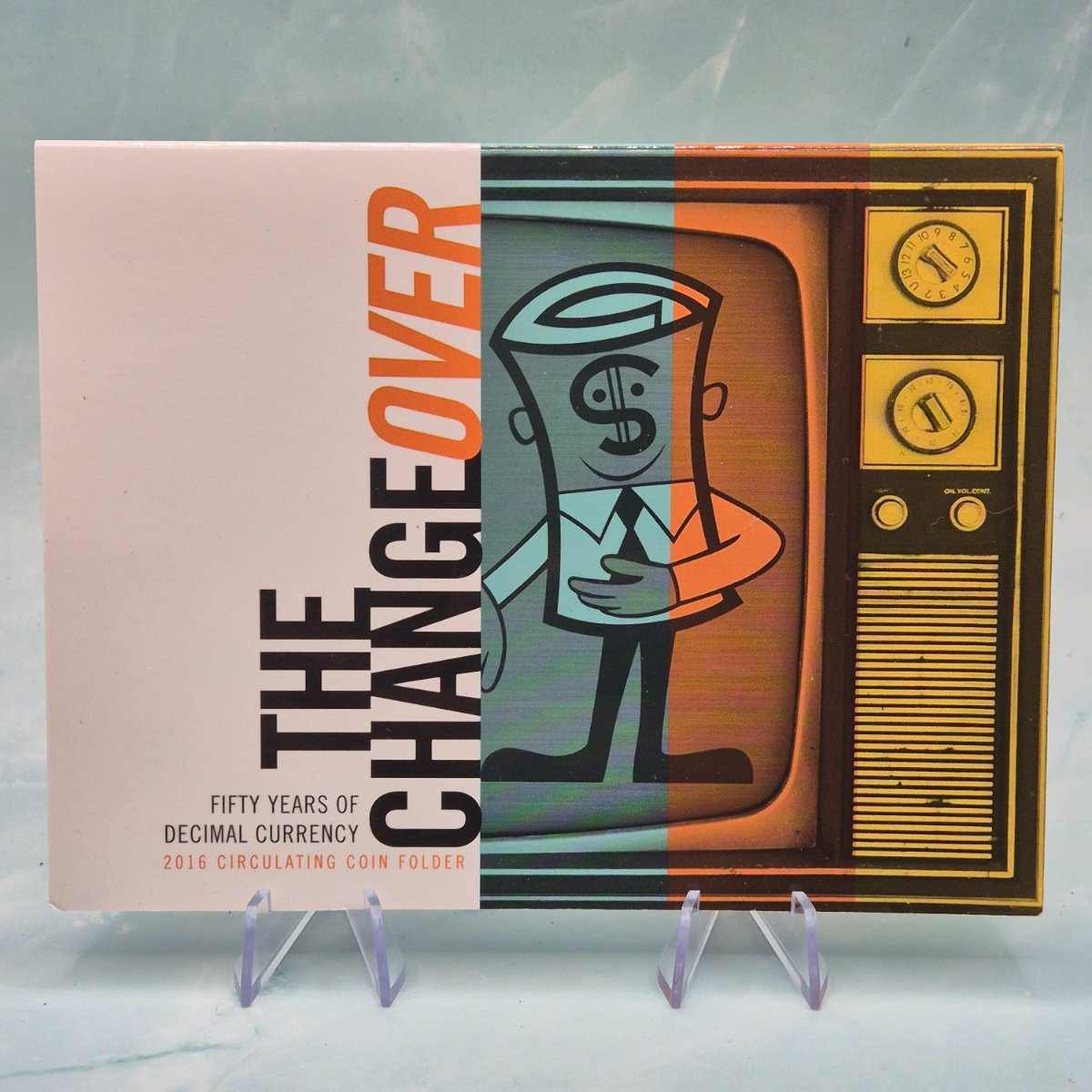 Coin folder titled 'The Change Over Fifty Years of Decimal Currency circulating coin folder' with a vintage television design showing 'Dollar Bill' mascot.