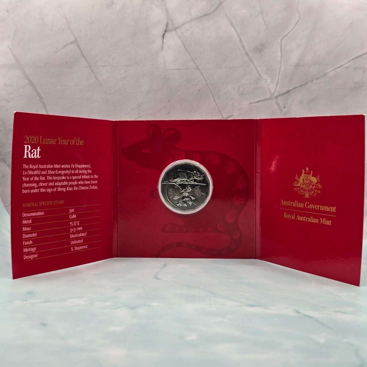 2020 50c Lunar Year of the Rat 50c Uncirculated Coin Tetra Decagon Series inner of red trifold with gold foil accents, and specifications