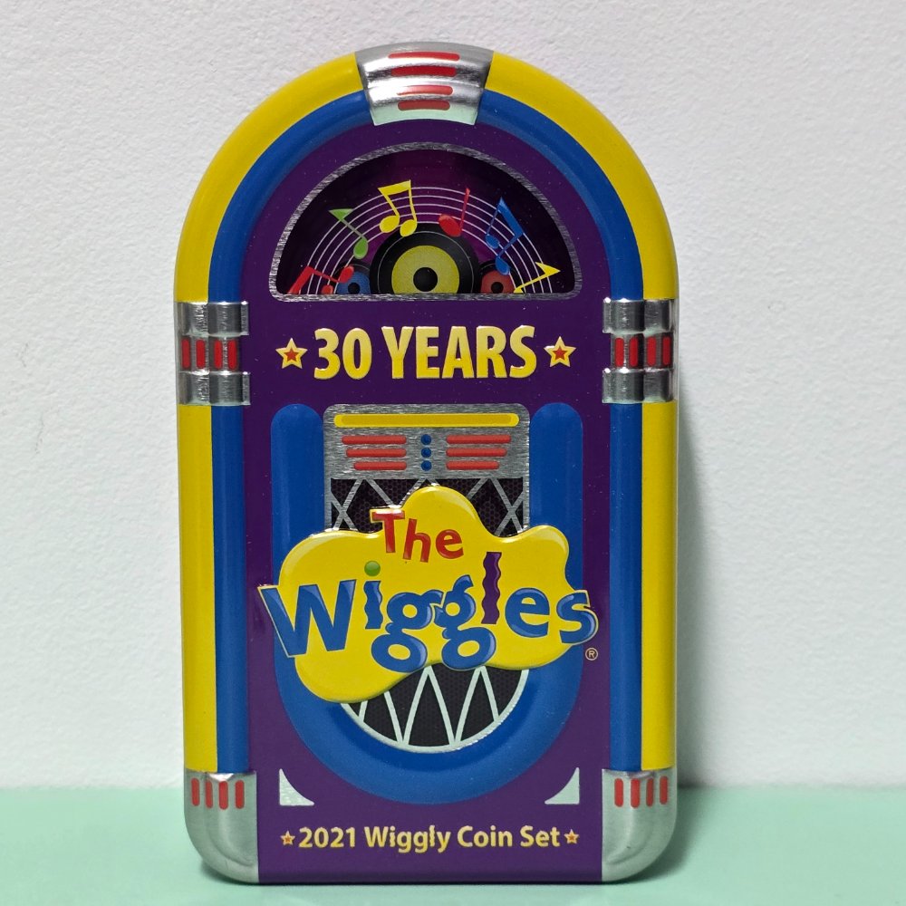 2021 30 years of the Wiggles Wiggly Coin Set Jukebox Tin with two scalloped 30c coins, front of tin