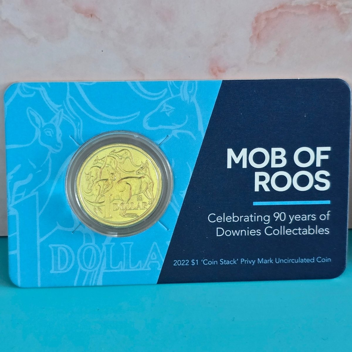 2022 $1 Mob of Roos coin with Coin Stack Privy Mark in small card with text 'Mob of Roos Celebrating 90 Years of Downies Collectables'