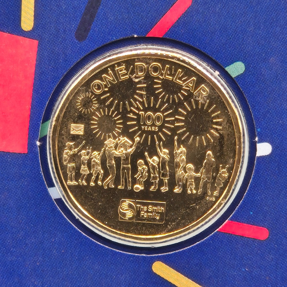 Close up of 2022 $1 Centenary of the Smith Family PNC with Envelope Privy Mark on the reverse of the $1 coin