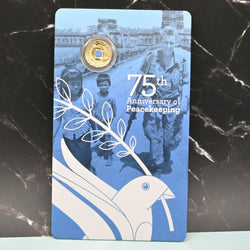 2022 $2 'C' Mintmark Peacekeeping coin on large card featuring a blue dove and text '75th Anniversary of Peacekeeping'