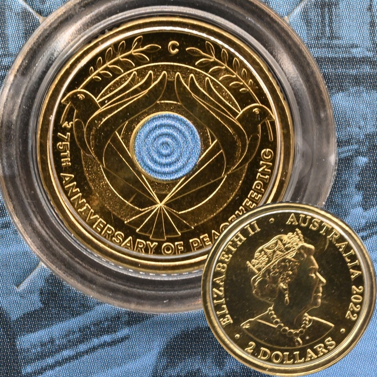 2022 $2 Peacekeeping Anniversary 'C' Mintmark Coin Reverse and small cut out showing the coin obverse with Queen Elizabeth II effigy