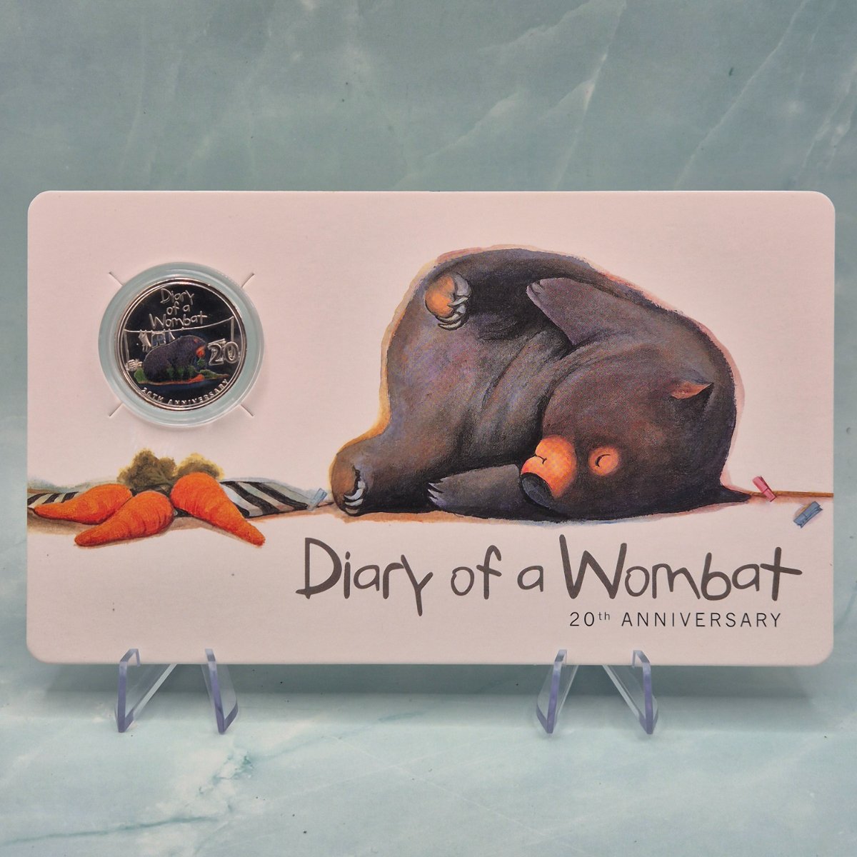 Product packaging for 'Diary of a Wombat' with wombat illustration and 2022 20c coin - reverse