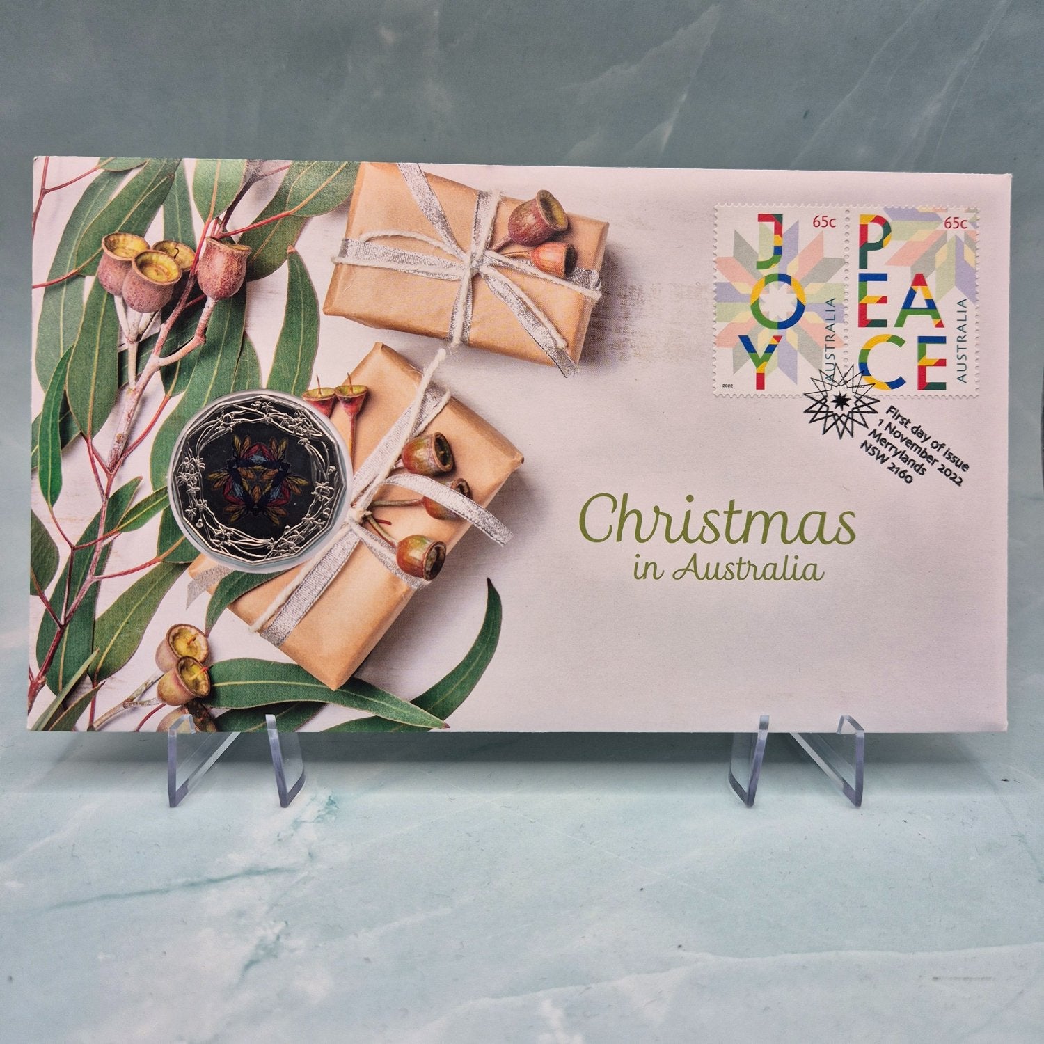 2022 50c Christmas in Australia PNC with native flora and coloured uncirculated coin featuring christmas beetles - reverse - text on envelope 'Christmas in Australia' -stamp text 'Joy' 'Peace'
