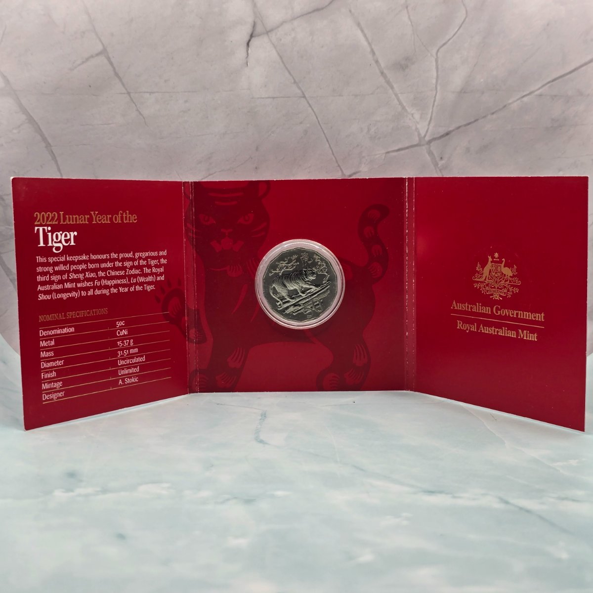 2022 50c Lunar Year of the Tiger 50c Uncirculated Coin Tetra Decagon Series inner of red trifold with gold foil accents