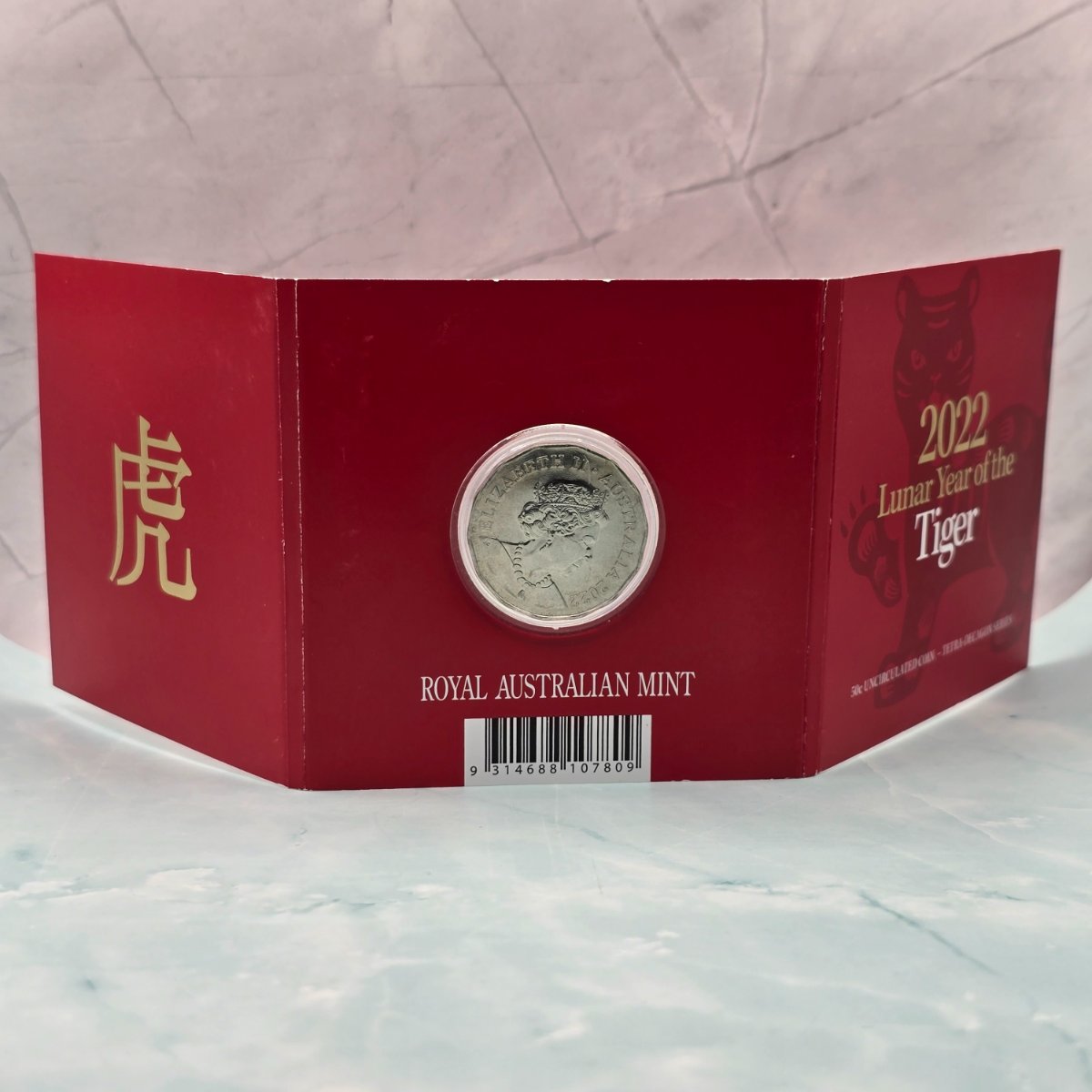 2022 50c Lunar Year of the Tiger 50c Uncirculated Coin Tetra Decagon Series back of red trifold with gold foil accents