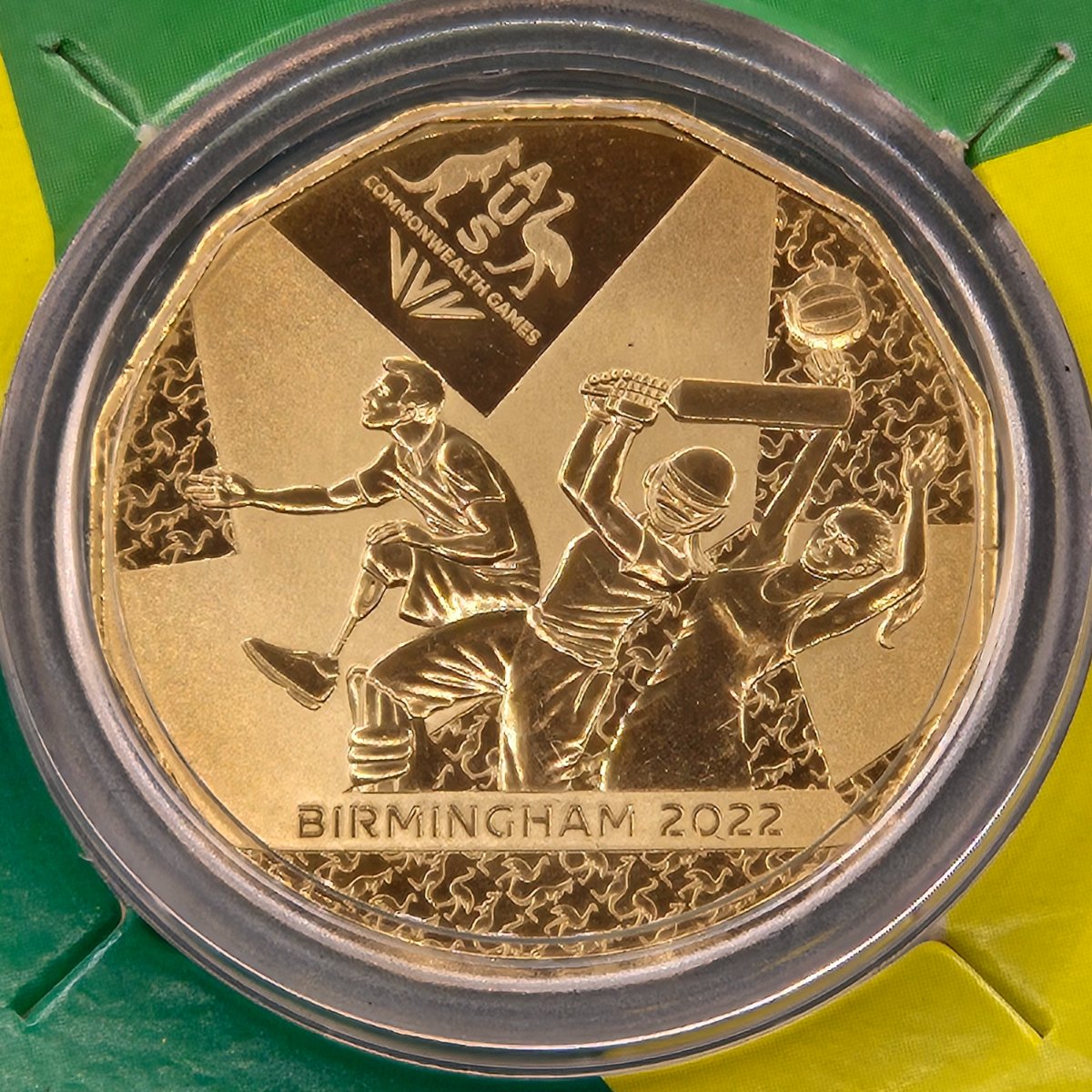 Close up of reverse side of 2022 Gold Plated 50c coin commemorating the Australian Commonwealth Games Team that competed in Birmingham on card