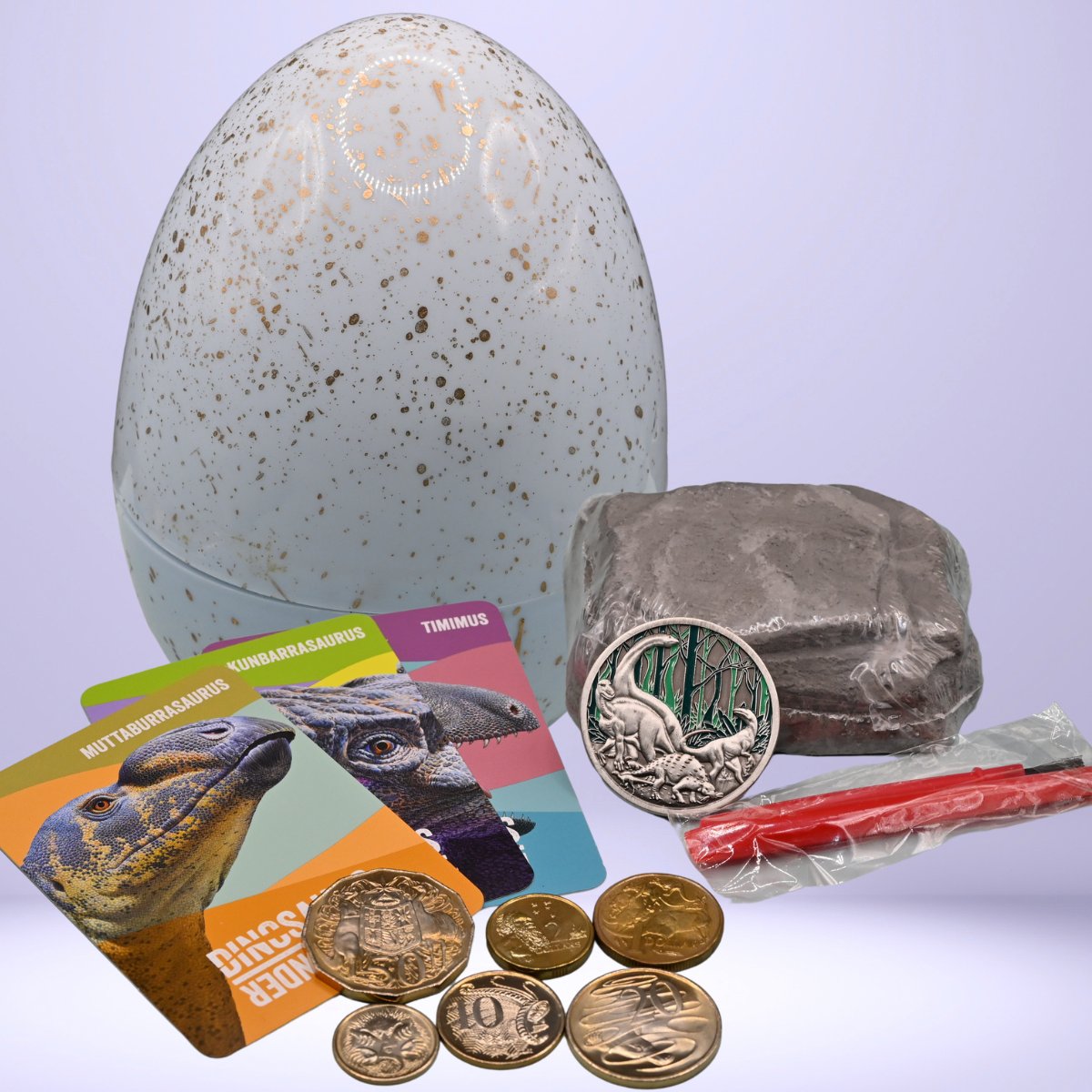 2022 Dino Discovery egg-shaped container with coins, cards, and other items