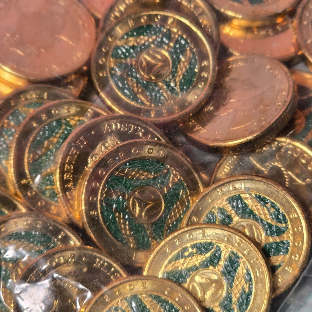 Close up of 2022 $2 coloured Socceroo coins in sealed security bag