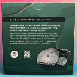 Back of 2023 $1 'C' Mintmark silver proof coin packaging with text and illustration of a blobfish, featuring the CSIRO logo.