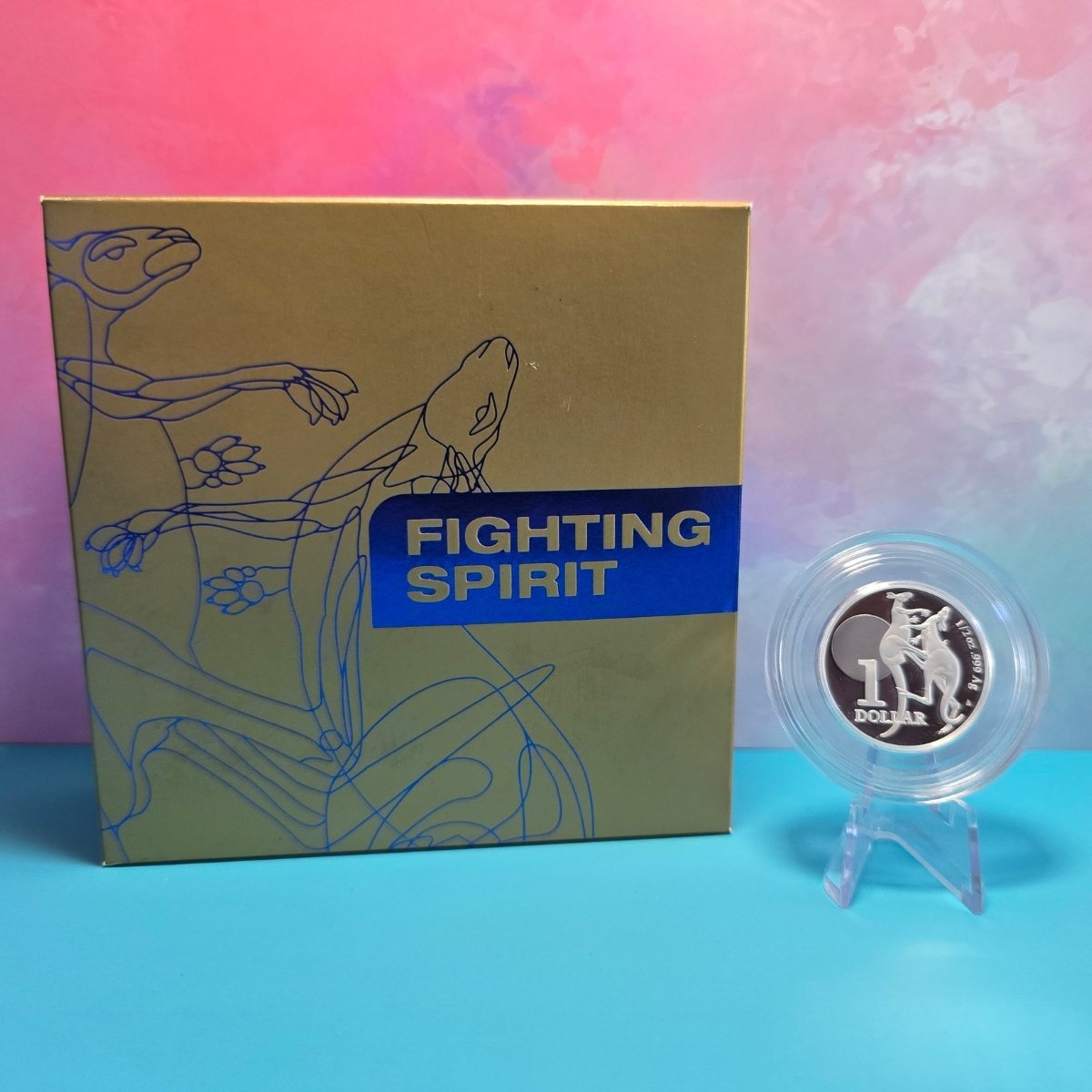 Gold box with 'Fighting Spirit' text and a 2023 $1 half ounce silver coin - reverse side