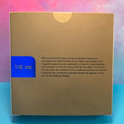 Coin box packaging coloured gold with text and blue '1/2 oz' label on a colorful background
