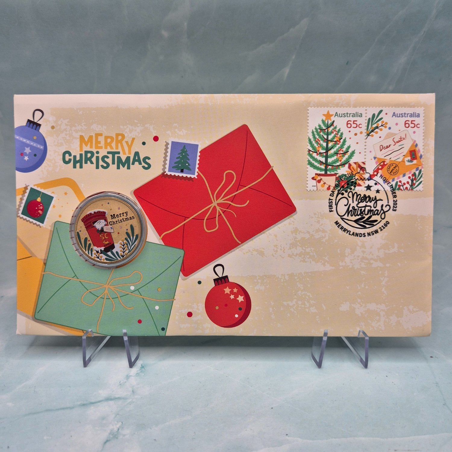 2023 $1 Perth Mint Merry Christmas PNC. Coloured coin reverse - Christmas gifts, baubles on envelope