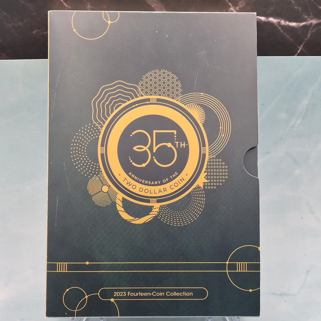 Green and gold packaging for a 2023 fourteen-coin collection with '35th Anniversary of the Two Dollar Coin' text.