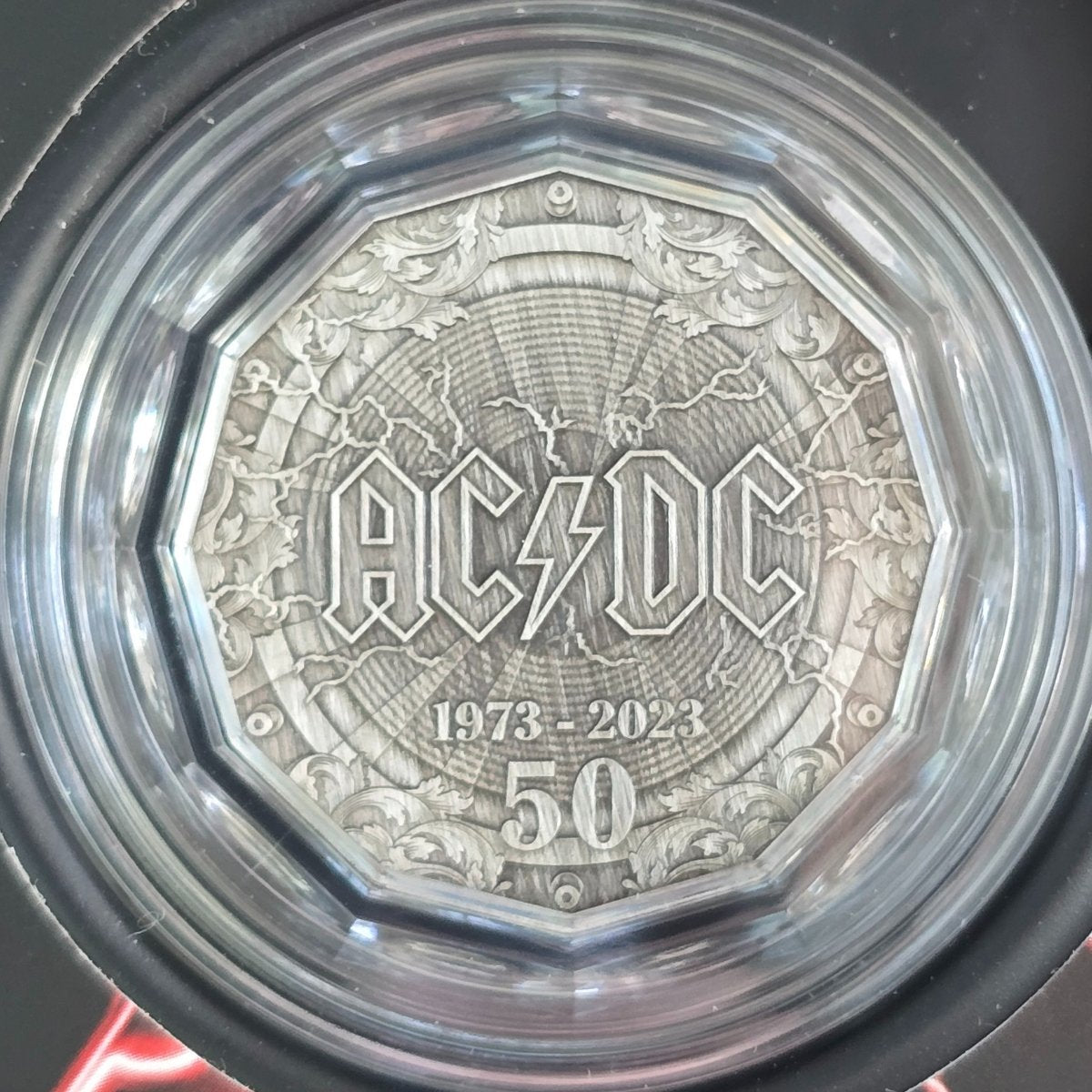 2023 50c Silver AC/DC antiqued finish coin with '1973-2023 50' text in a protective case - reverse