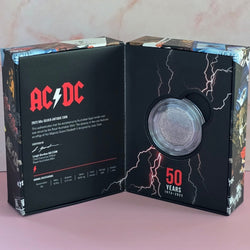 2023 50c AC/DC 50th anniversary silver coin packaging with visible brand logo.