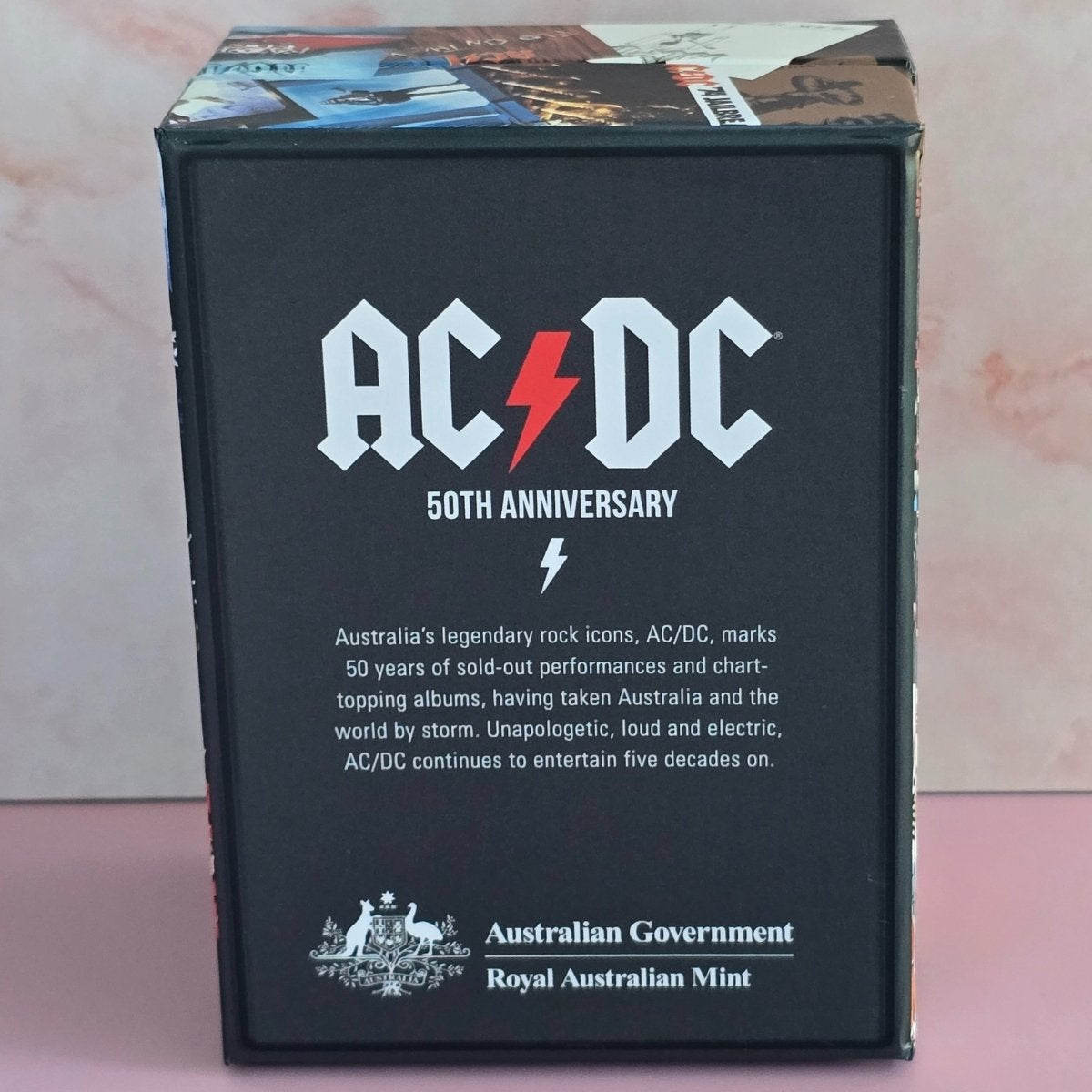 AC/DC 50th Anniversary silver antique finish 2023 50c product packaging with branding and text
