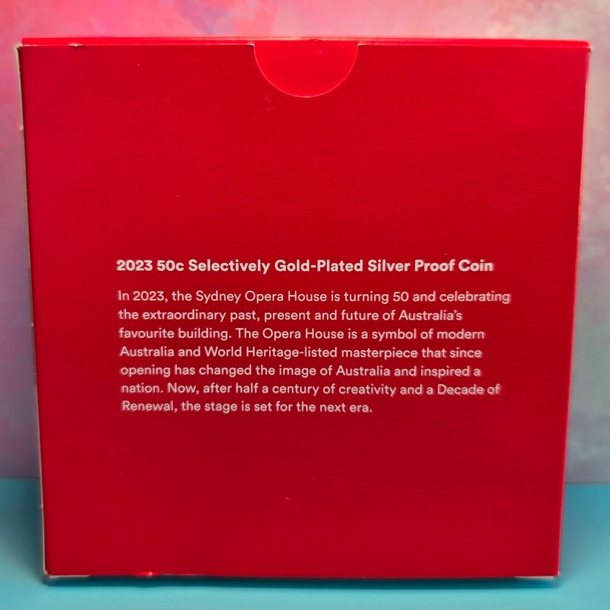 Red box with text about a 2023 50c Selectively Gold-Plated Silver Proof Coin related to the Sydney Opera House.