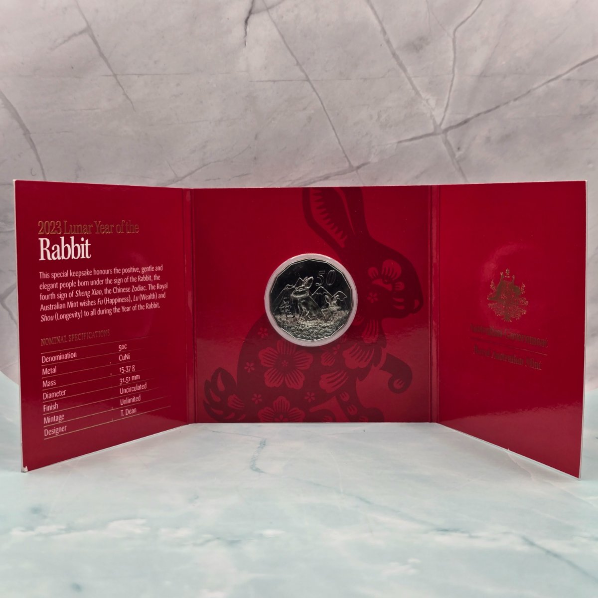 2023 50c Lunar Year of the Rabbit 50c Uncirculated Coin Tetra Decagon Series inner of red trifold with gold foil accents and specifications on left