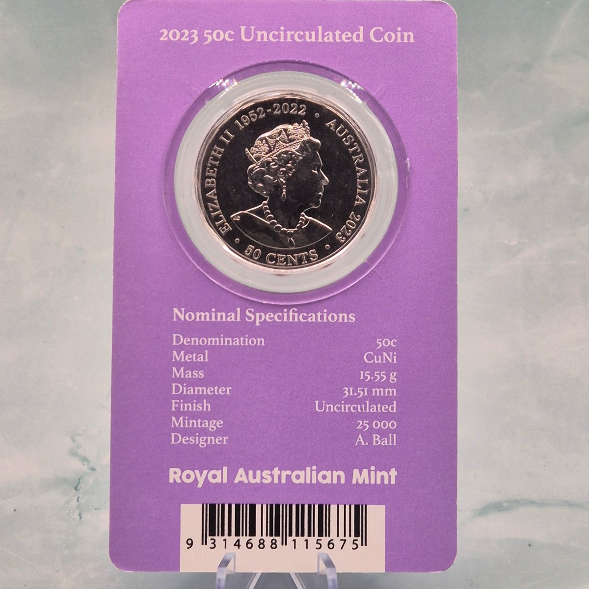 Back and obverse of 2023 50c EIIR Her Majesty Queen Elizabeth II Memorial commemorative coin in a purple card