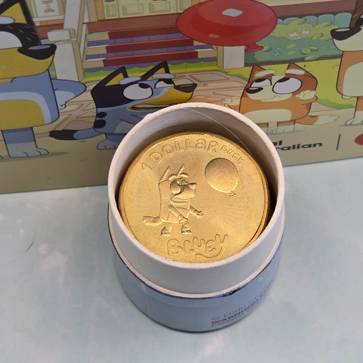 2024 $1 Bluey opened 10 Coin Tube and Folder struck by the Royal Australian Mint - Dollar Bucks - close up of opened tube with non-coloured Bluey top coin