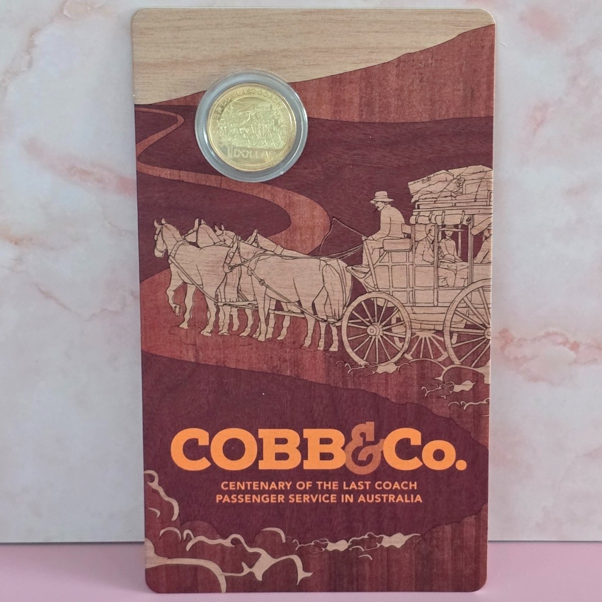 Large Royal Australian Mint card with 2024 $1 coin on top featuring 'COBB&Co.' branding and illustrations of a coach and horses.