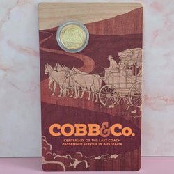 Large Royal Australian Mint card with 2024 $1 coin on top featuring 'COBB&Co.' branding and illustrations of a coach and horses.