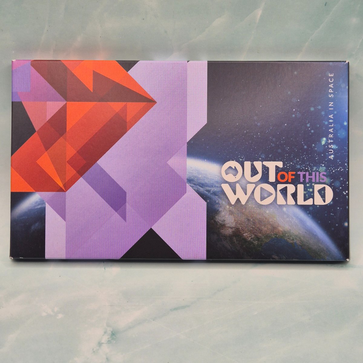 Product packaging of a 4x $1 coin Privy Mark and Mintmark set with geometric design and 'Out of This World'