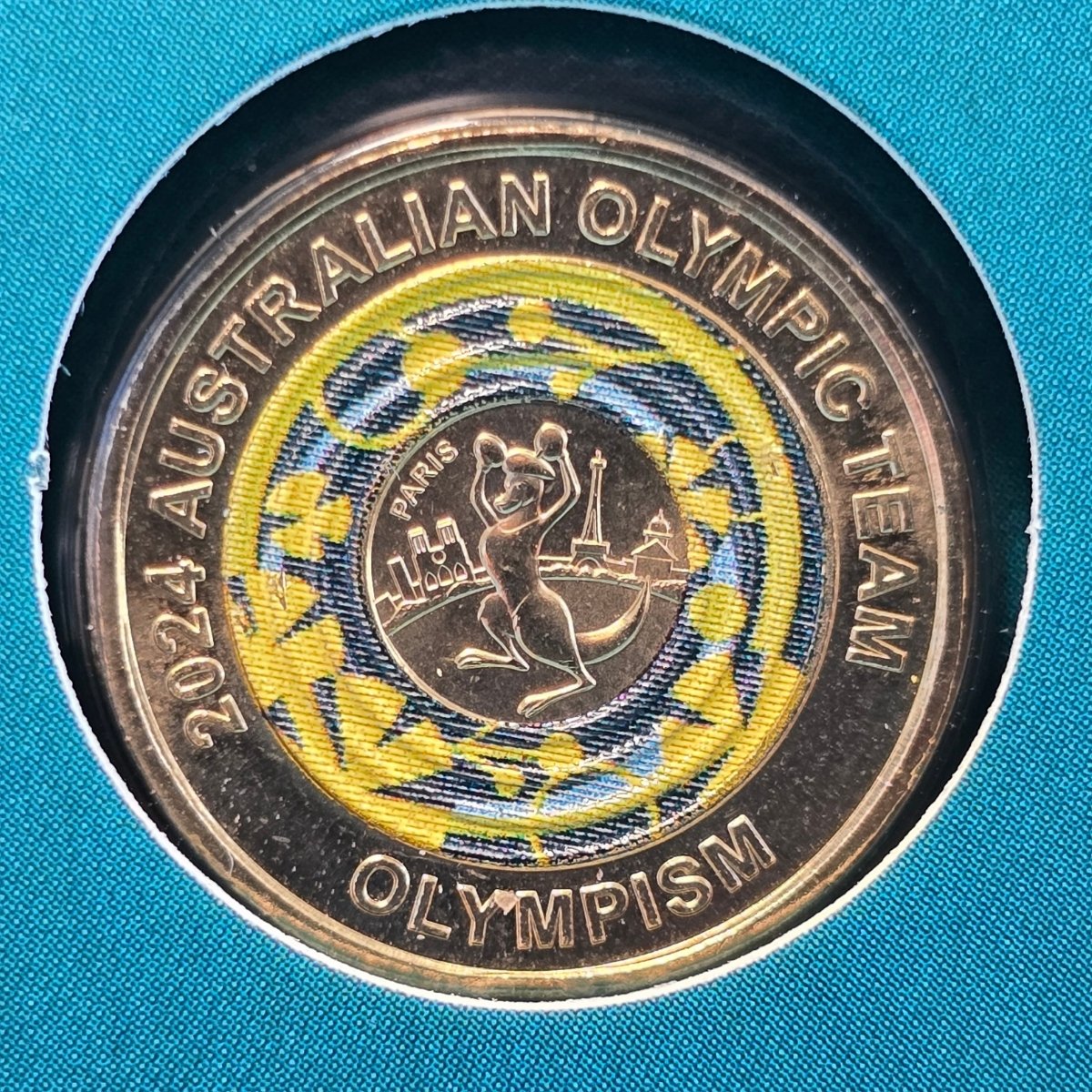 2024 $2 coin with 'Australian Olympic Team' and 'Olympism' text colour surrounds an image of a boxing kangaroo with gloves raised in victory wearing a beret - reverse of coin