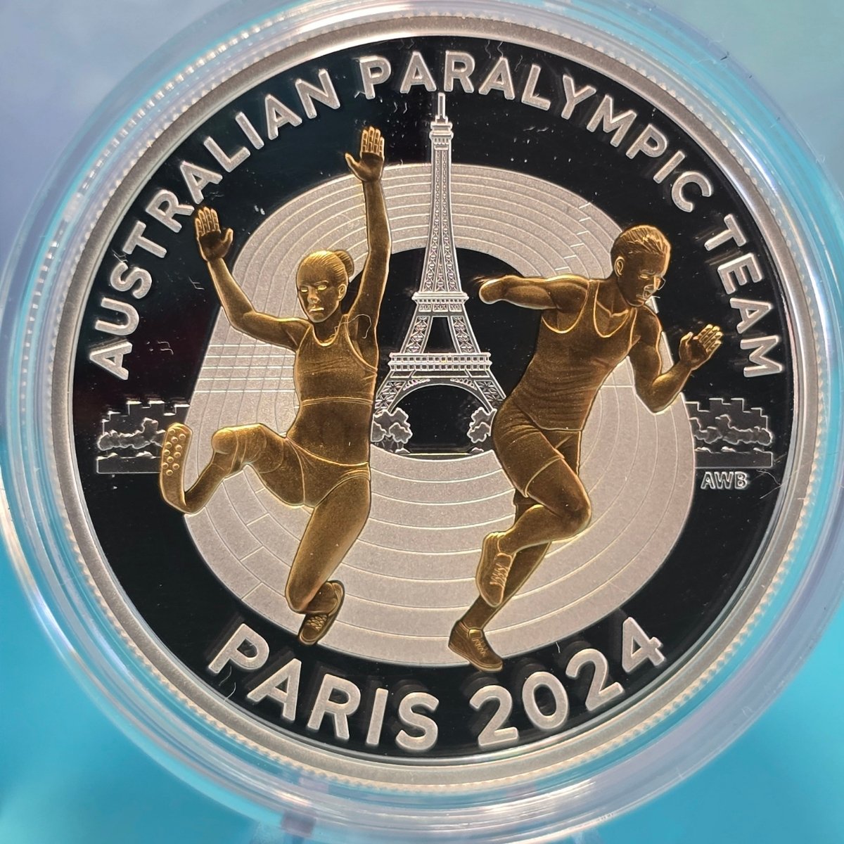 2024 $5 Selectively gold plated silver coin featuring text 'Australian Paralympic Team' with 'Paris 2024' Paralympians and Eiffel Tower - reverse of coin