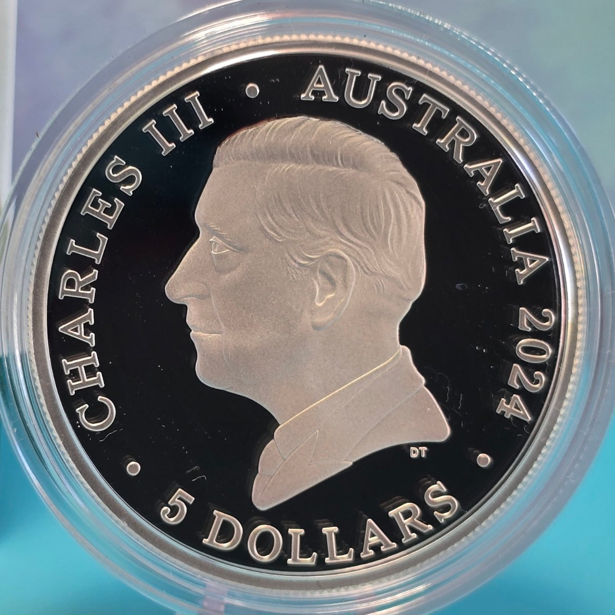 Silver coin with a profile of a monarch and text 'Charles III Australia 2024 5 Dollars' on a clear background