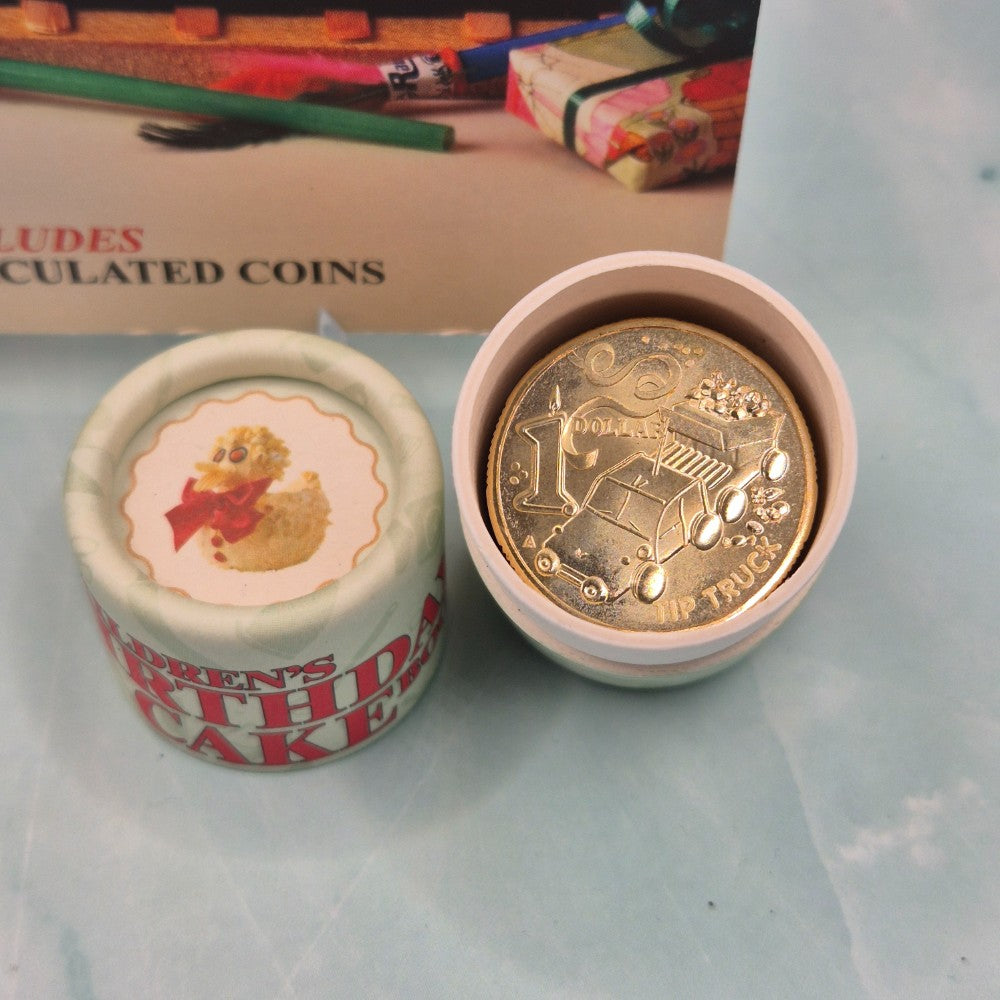 2025 $1 Women's Weekly Children's Birthday Cake Book Tube and Folder 10 coin set opened showing Tip Truck