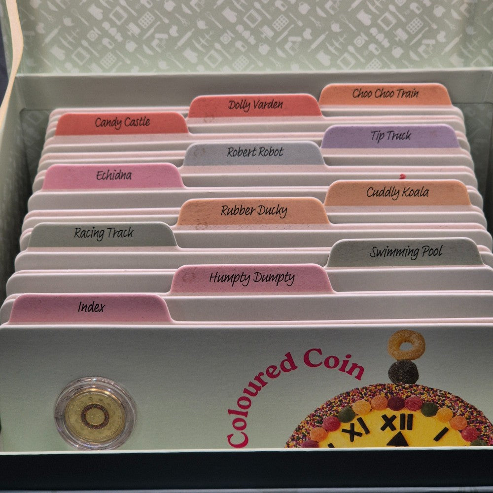 2025 Women's Weekly Birthday Cake 12 Coin Recipe Box with 11x $1 carded coins and 1x $2 carded coloured Hickory Dickory Watch coin